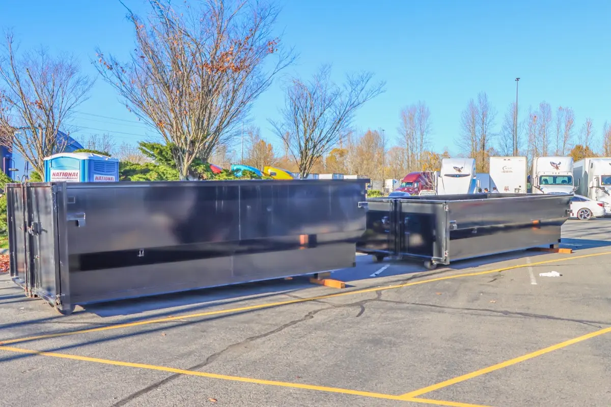 Professional dumpster rental service with roll-off container on residential driveway in Windsor